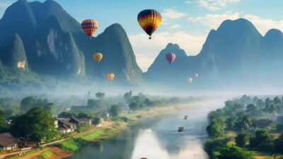 Hot air balloons over the limestone towers at Vang Vieng